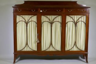 A good Maple & Co inlaid mahogany display cabinet, with three drawers over three doors with shaped