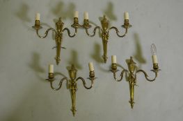 A set of four gilt brass two branch wall lamps, 34cm long