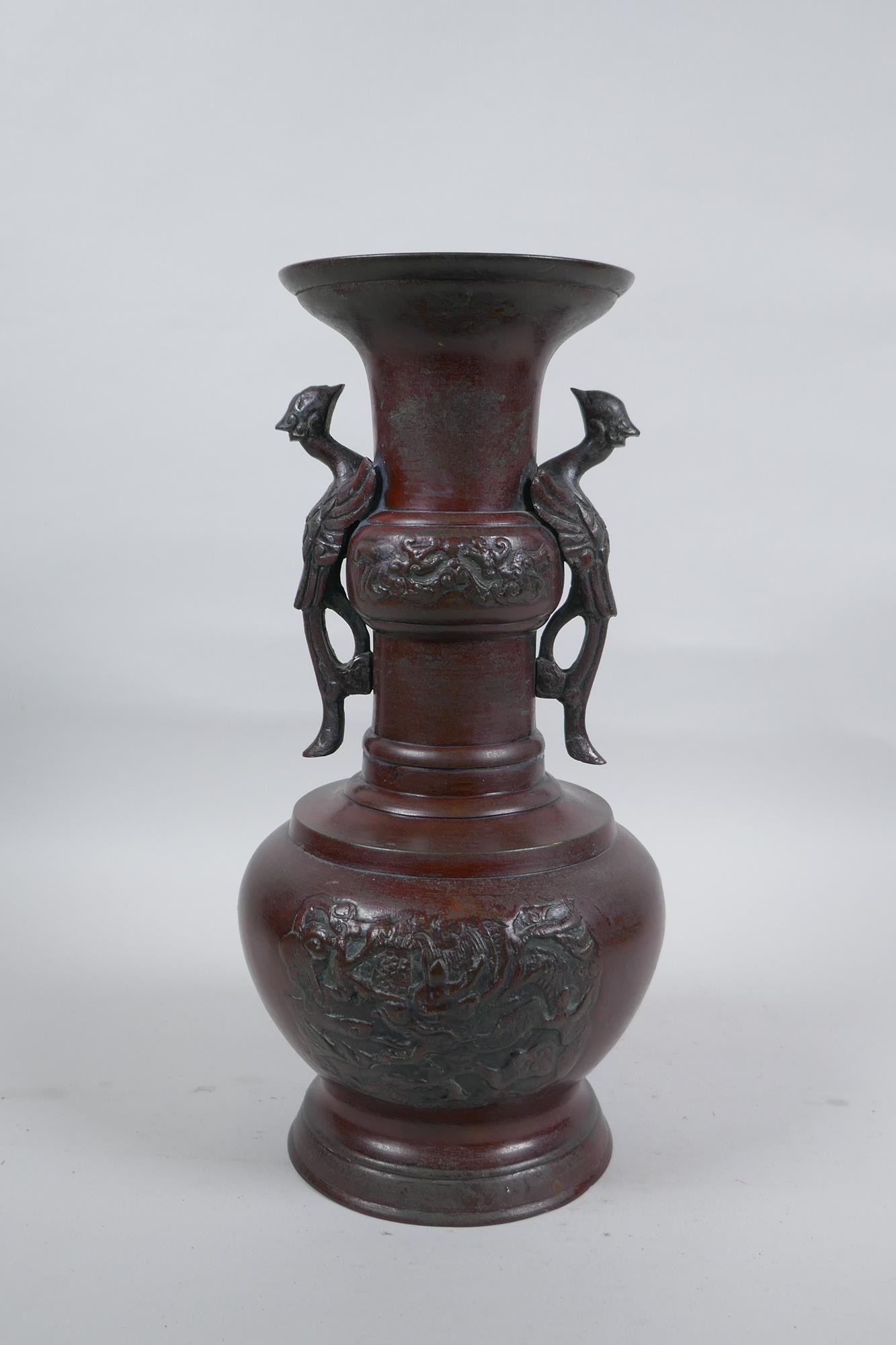 A Chinese bronze vase with two phoenix handles and raised panels depicting dragons, 30cm high - Image 4 of 6