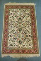 A Persian cream ground Tabriz rug with multi colour all over floral design and red borders, 150 x