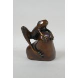 After Phil Vanderlei (American), a bronze figure of a frog on a rock, 15cm high