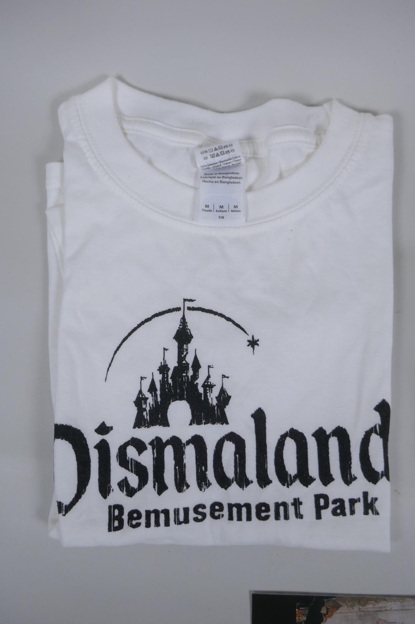 After Banksy, a Dismaland brochure, Dismaland T-shirt (child size M), and two FCK-PTN! postcards, - Image 4 of 8