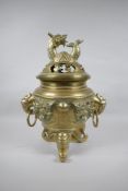 A Chinese bronze censer and cover with tripod elephant head supports, twin dragon head loop handles,