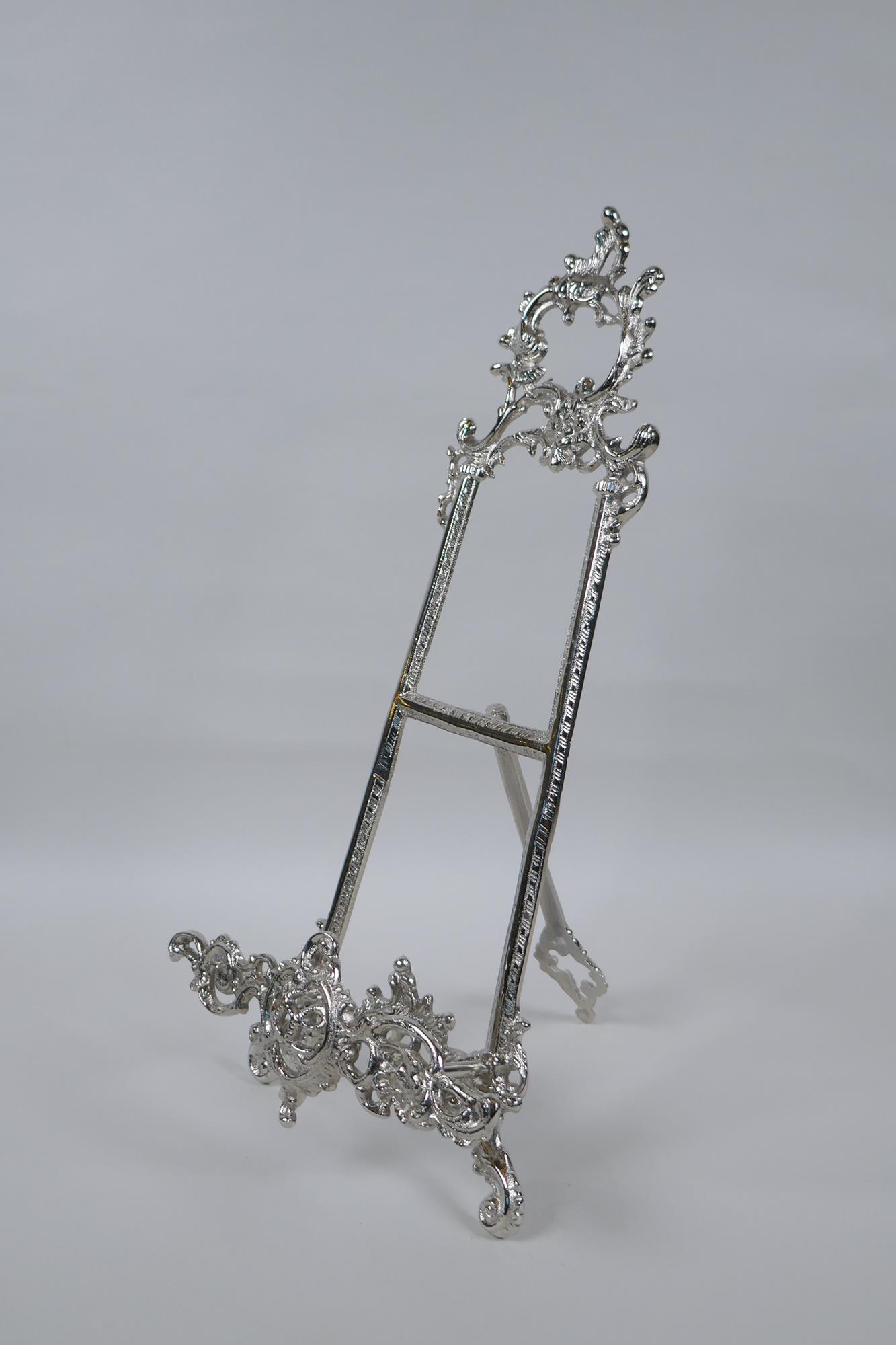 A silvered metal easel, 40cm high
