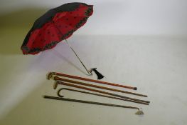 Four vintage walking sticks with brass, horn, walnut and bamboo handles, together with a collapsable