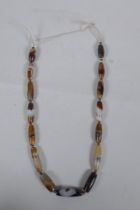 A string of graduated banded agate beads, 66cm long