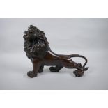 A filled bronze figure of a lion, 26cm long