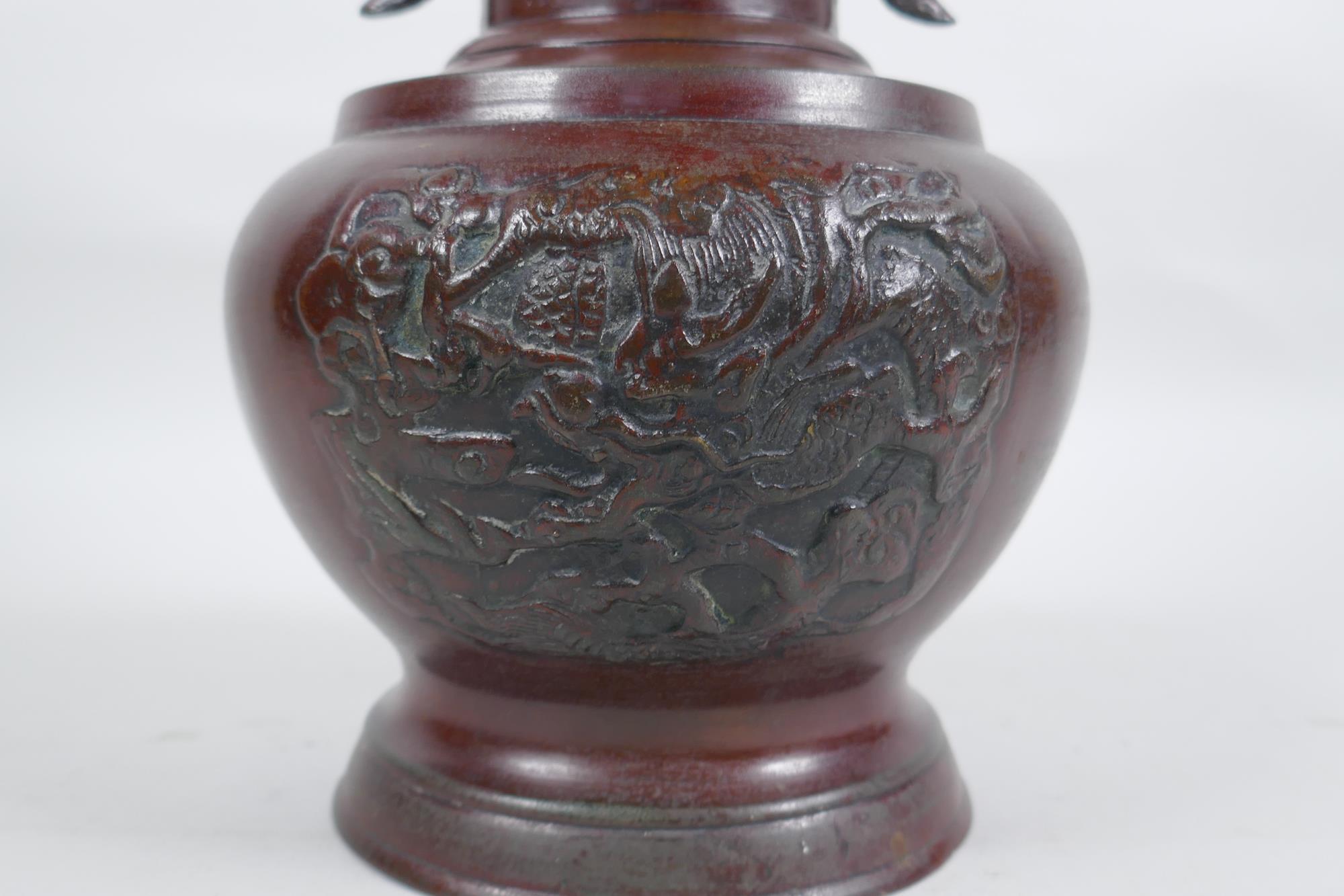 A Chinese bronze vase with two phoenix handles and raised panels depicting dragons, 30cm high - Image 5 of 6