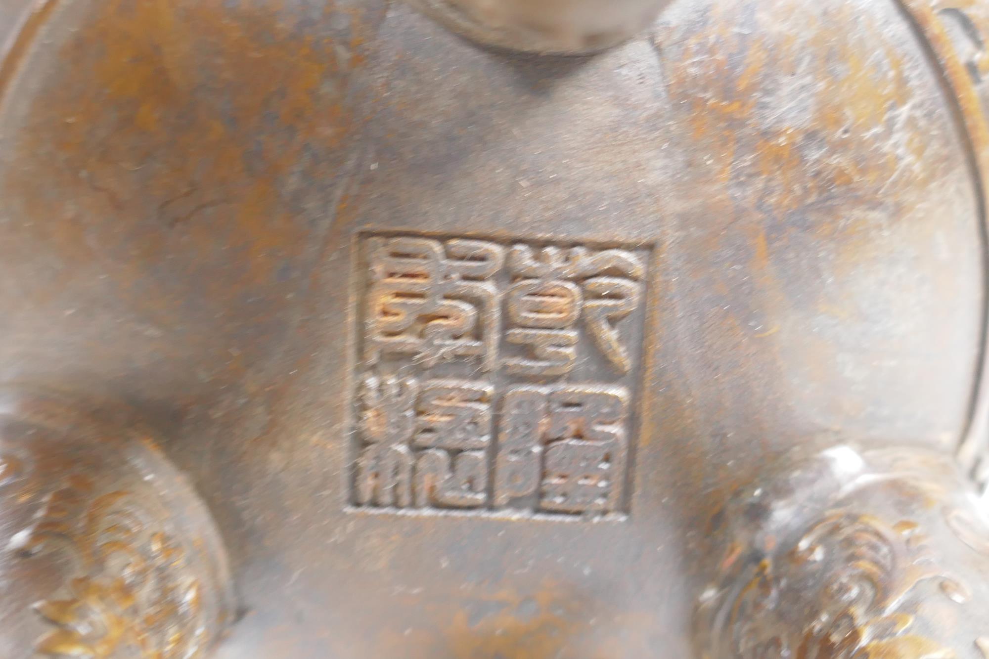 A Chinese bronze censer and cover on tripod supports, with two ruyi shaped handles and allover lotus - Image 3 of 5