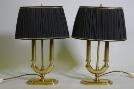 A pair of brass two branch table lamps with pleated shades, 49cm high with shades