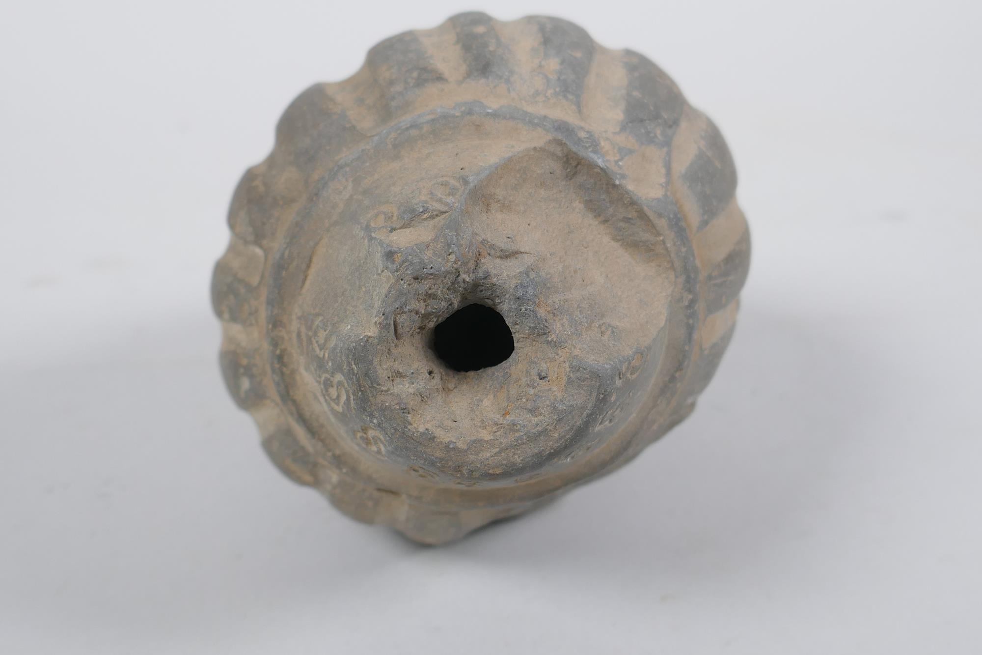 An early ceramic hand grenade/bomb, possibly C12th/C13th, with ribbed body and impressed motifs, - Image 5 of 5
