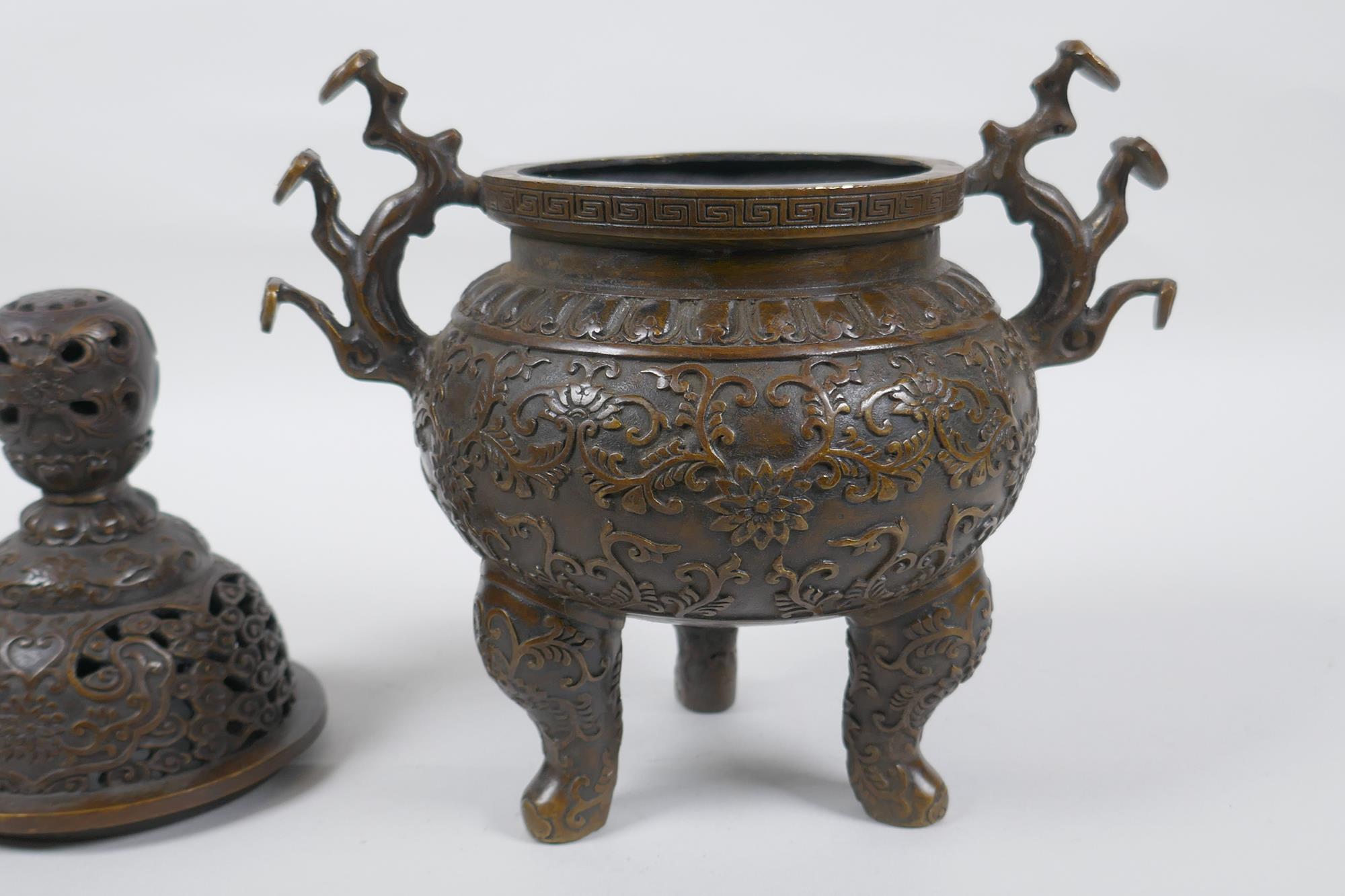 A Chinese bronze censer and cover on tripod supports, with two ruyi shaped handles and allover lotus - Image 5 of 5