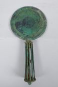 An antique bronze hand mirror, possibly Etruscan, 29cm long