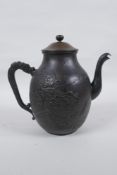 A Japanese bronze teapot with raised dragon and landscape decoration, character mark to base, 20cm