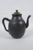 A Japanese bronze teapot with raised dragon and landscape decoration, character mark to base, 20cm