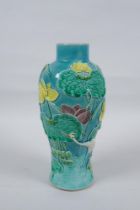 A C19th Chinese Sancai glazed porcelain vase with raised decoration of a wading bird in a lotus