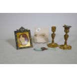 An antique French enamelled miniature print in gilt frame, a pair of ormolu candlesticks, a