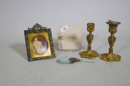 An antique French enamelled miniature print in gilt frame, a pair of ormolu candlesticks, a