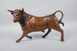A filled coppered metall bull, 30cm long