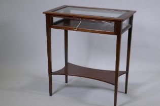 An Edwardian inlaid mahogany bijouterie table, raised on tapering supports united by a shaped