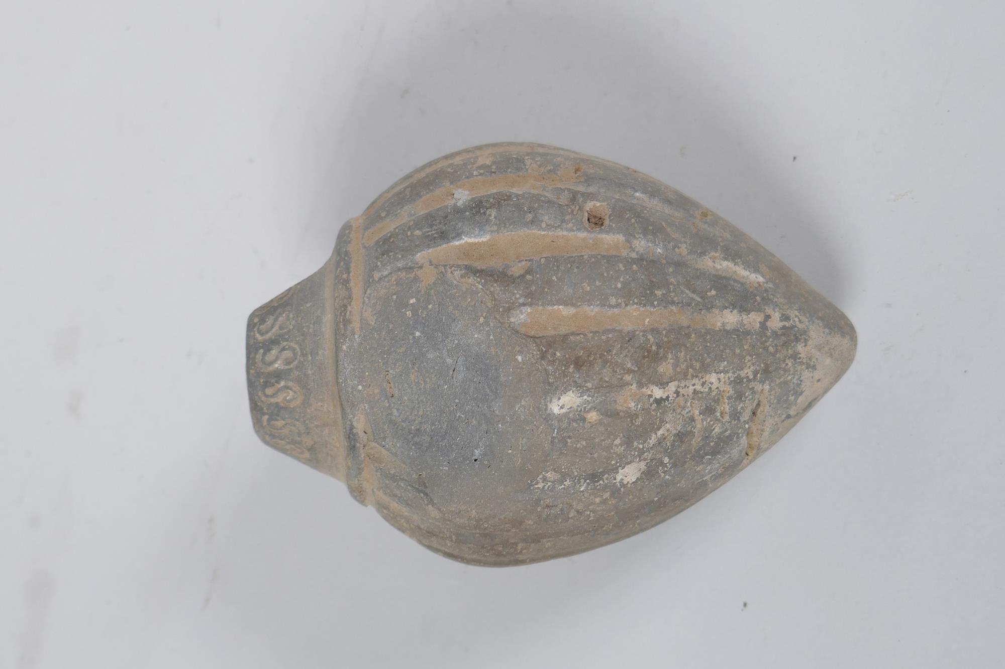 An early ceramic hand grenade/bomb, possibly C12th/C13th, with ribbed body and impressed motifs, - Image 4 of 5