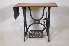 A Victorian cast iron sewing machine table, with later tiled top, 86 x 41 x 74cm