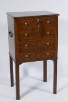 A George III mahogany cellarette, with four false drawers and lift up top revealing a sectioned