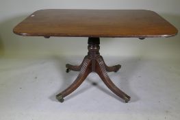 A Regency mahogany tilt top breakfast table, with single piece top and reeded edge, raised on turned