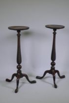 A pair of late C19th/early C20th mahogany torchere  stands on tripod supports with spiral carved