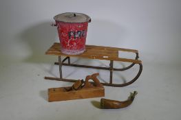 A vintage child's sled, a painted galvanised metal fire bucket, brass mounted hunting horn and a