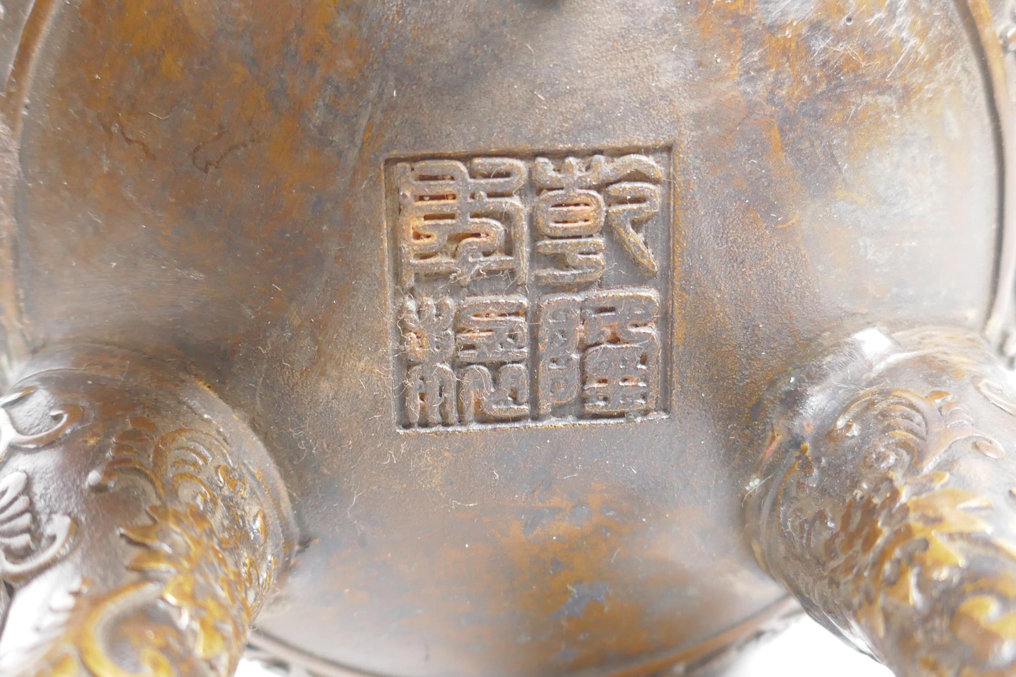 A Chinese bronze censer and cover on tripod supports, with two ruyi shaped handles and allover lotus - Image 4 of 5