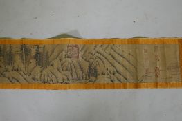 A Chinese watercolour scroll depicting an extensive cliffside landscape, 23cm high