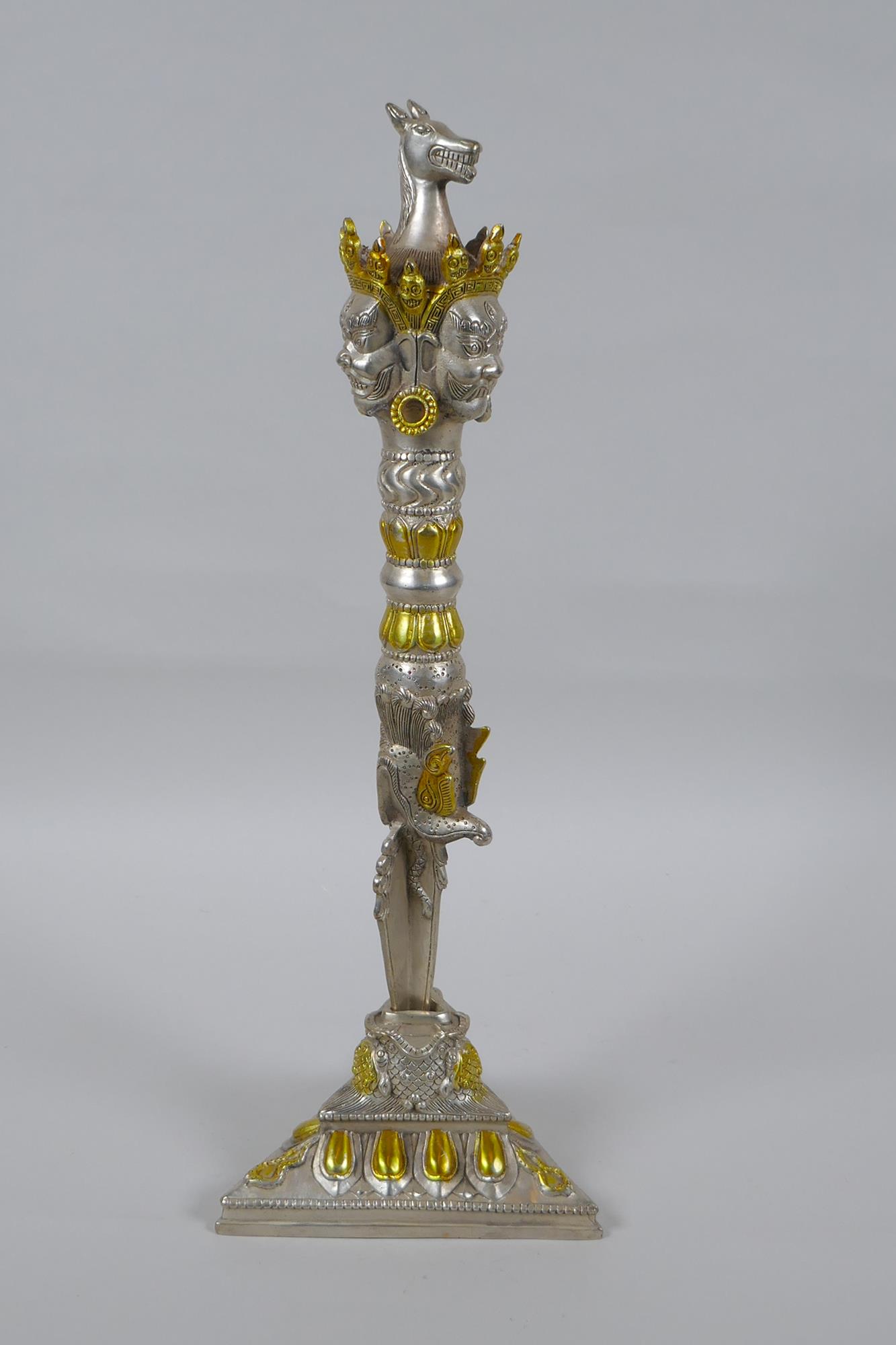 A Tibetan ceremonial metal phurba and stand with gilt metal highlights and wrathful deity masks to - Image 3 of 5