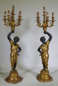 A pair of composition blackamoor five branch torcheres, 126cm high