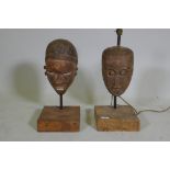 Two antique African painted and carved wood masts, partially converted to lamps, 53cm high