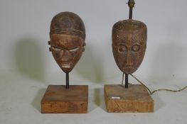 Two antique African painted and carved wood masts, partially converted to lamps, 53cm high