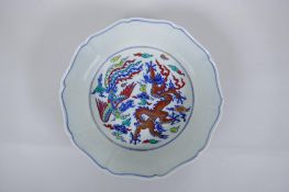 A Chinese Wucai porcelain steep sided bowl of lobed form, with allover dragon and phoenix