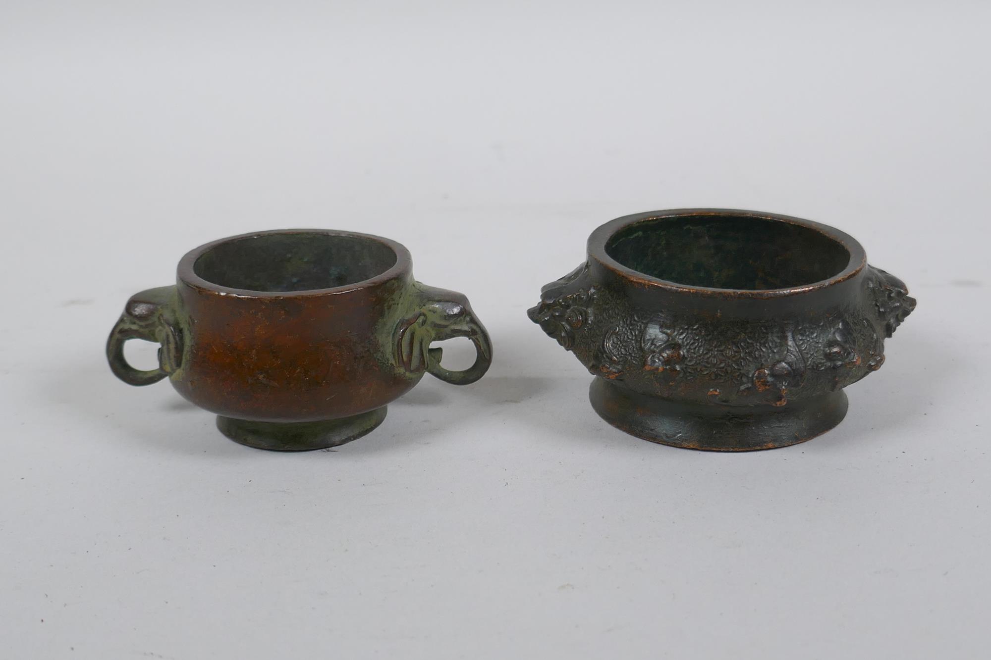 A miniature Chinese bronze censer with two elephant mask handles, and another with lion mask handles