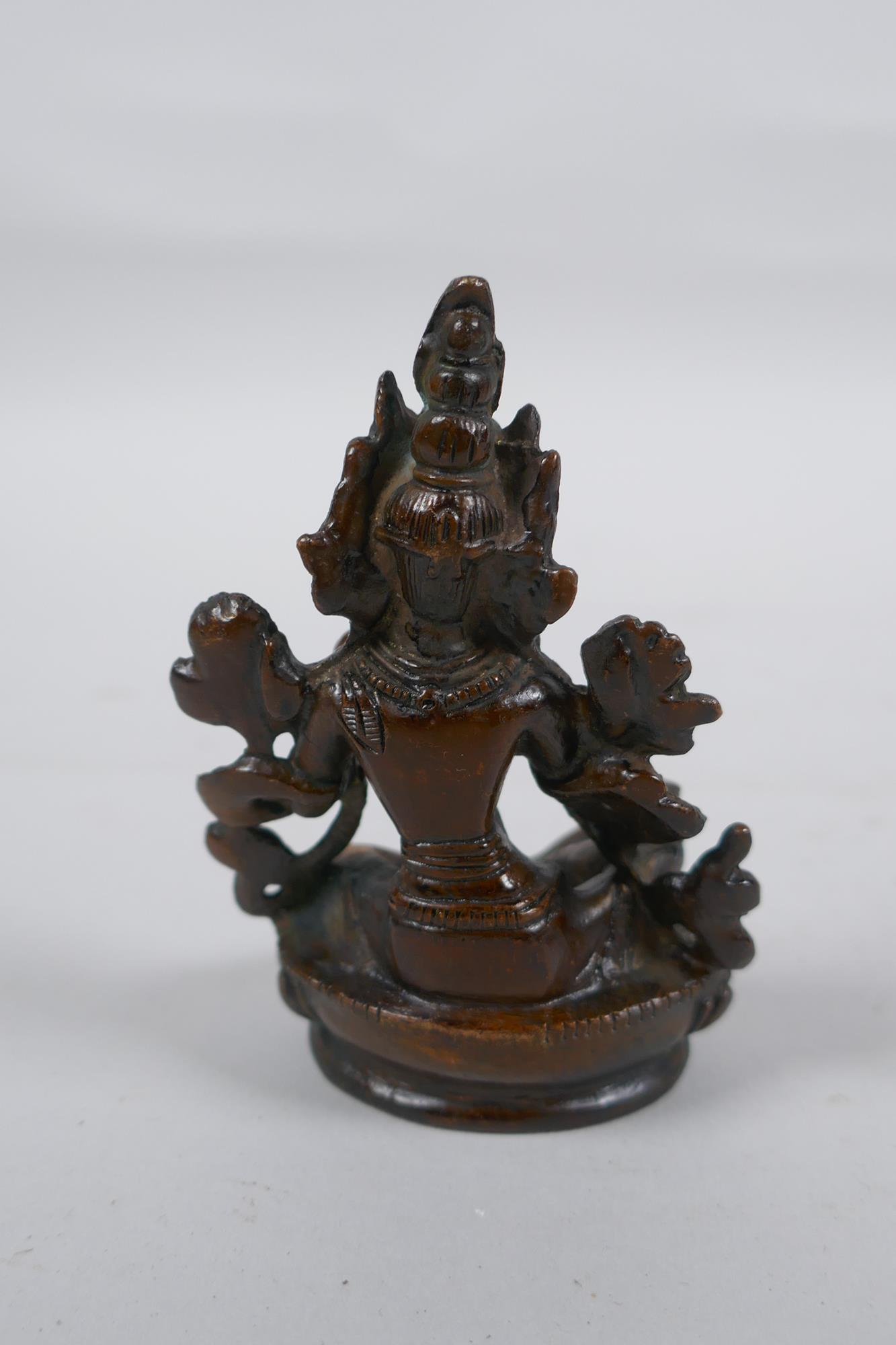 A Tibetan bronze of Green Tara, 9cm high - Image 2 of 3