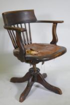 A late C19th/early C20th beechwood bow back tilt and swivel office chair