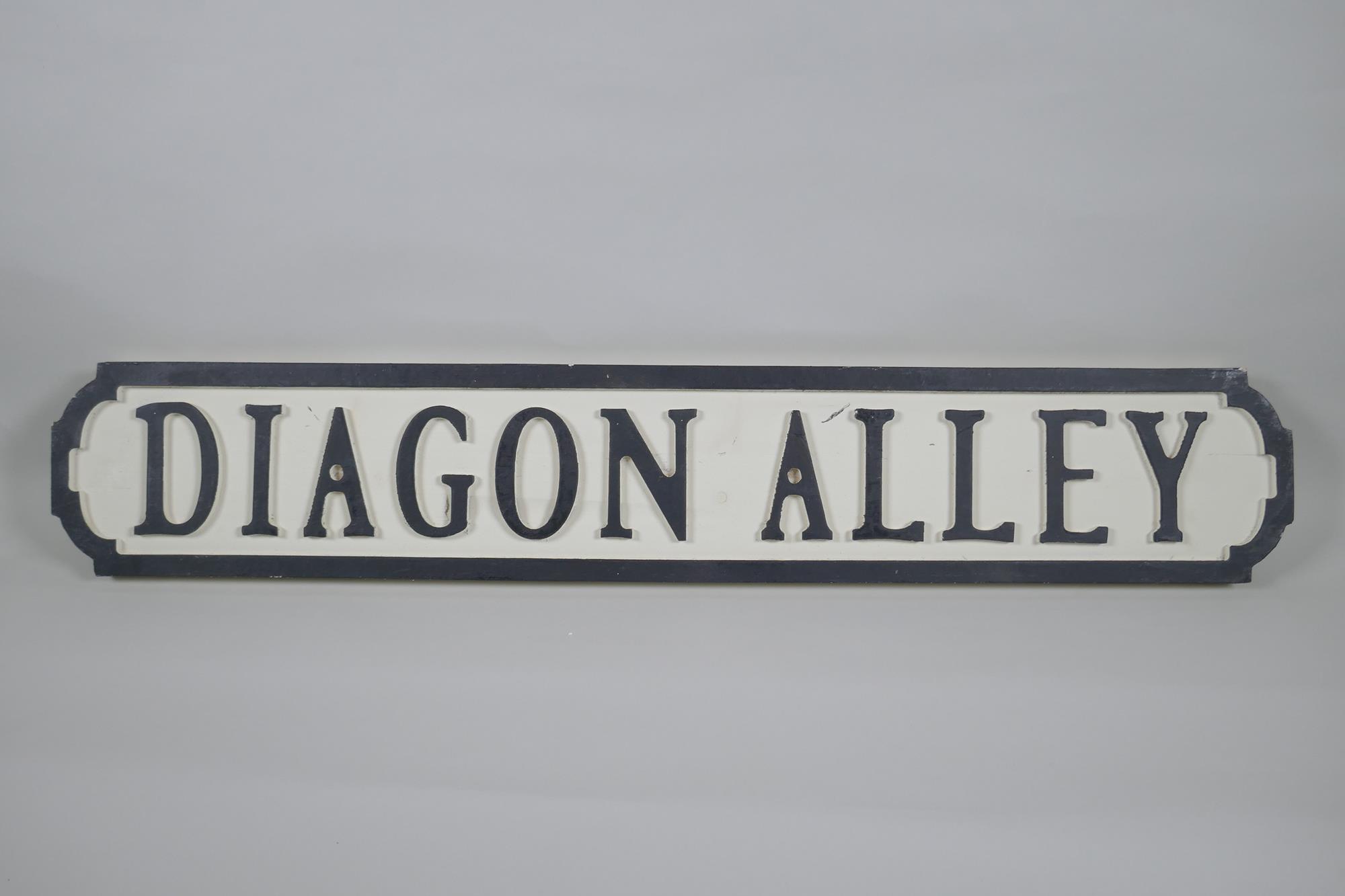 A painted wood Harry Potter 'Dragon Alley' road sign, 14 x 78cm long