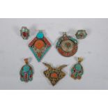 A collection of Tibetan coral and turquoise set gilt metal pendants and rings