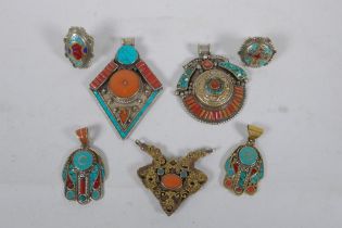 A collection of Tibetan coral and turquoise set gilt metal pendants and rings