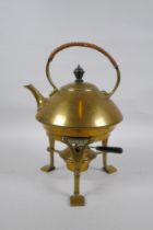 An Arts and Crafts brass spirit kettle, 29cm high