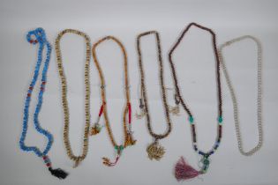Six assorted strings of Tibetan Mala beads including turquoise, bone, nut, stone etc