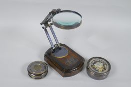 A brass desk top magnifying glass and two reproduction brass compasses, lens 8cm diameter, 1AF