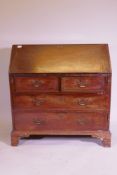 A George III mahogany fall front bureau, the interior with pigeon holes and drawers and secret