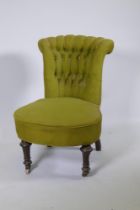 A small Victorian nursing chair with button back, raised on turned fluted supports, 70cm high