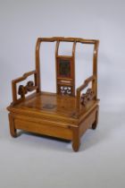 An antique Chinese pine shopkeeper's low chair, with carved panel back, 54 x 42cm, 67cm high