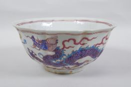 A Chinese polychrome porcelain bowl with lobed rim, decorated with dragons to the exterior and
